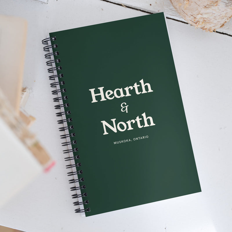 The Field Journal in spruce with the cream wordmark, front cover.
