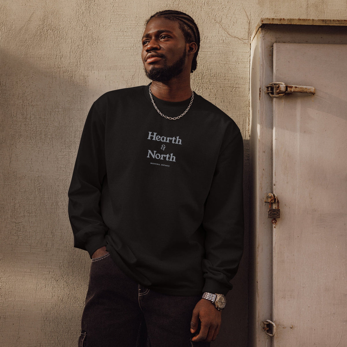 Wordmark Long Sleeve in black, worn outdoors, front view.