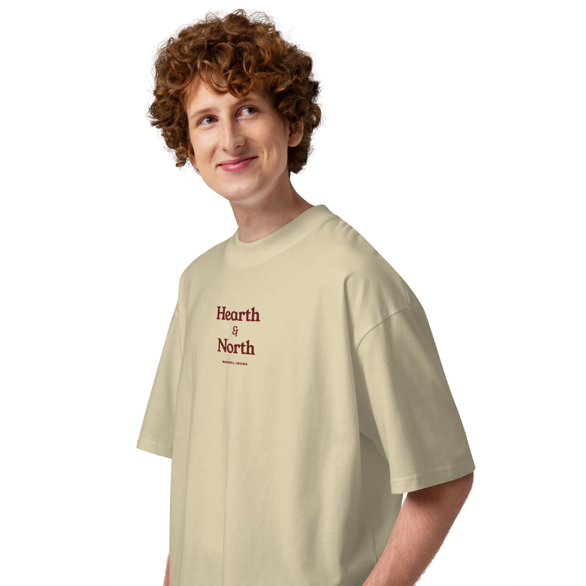 Side view of the Wordmark Oversized Tee in stone showing the dropped shoulder.